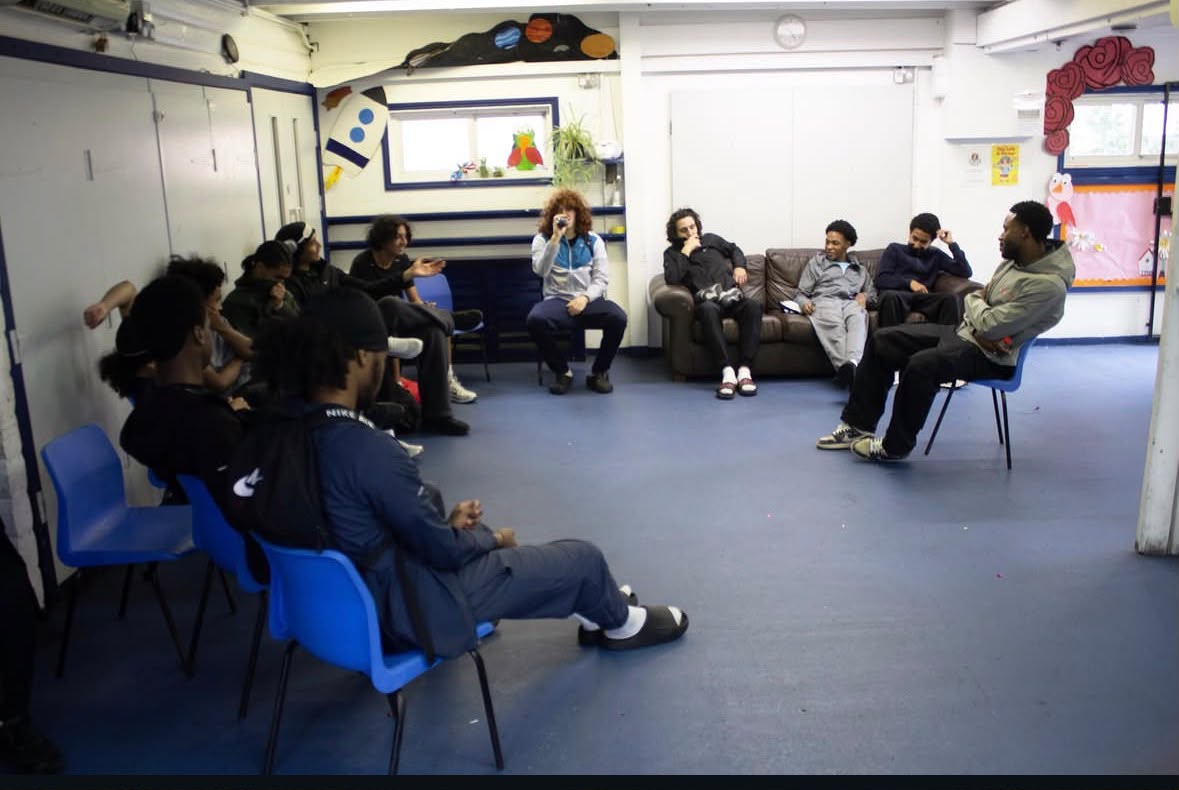 Young men from Camden United in a circle discussion during a mental resilience workshop